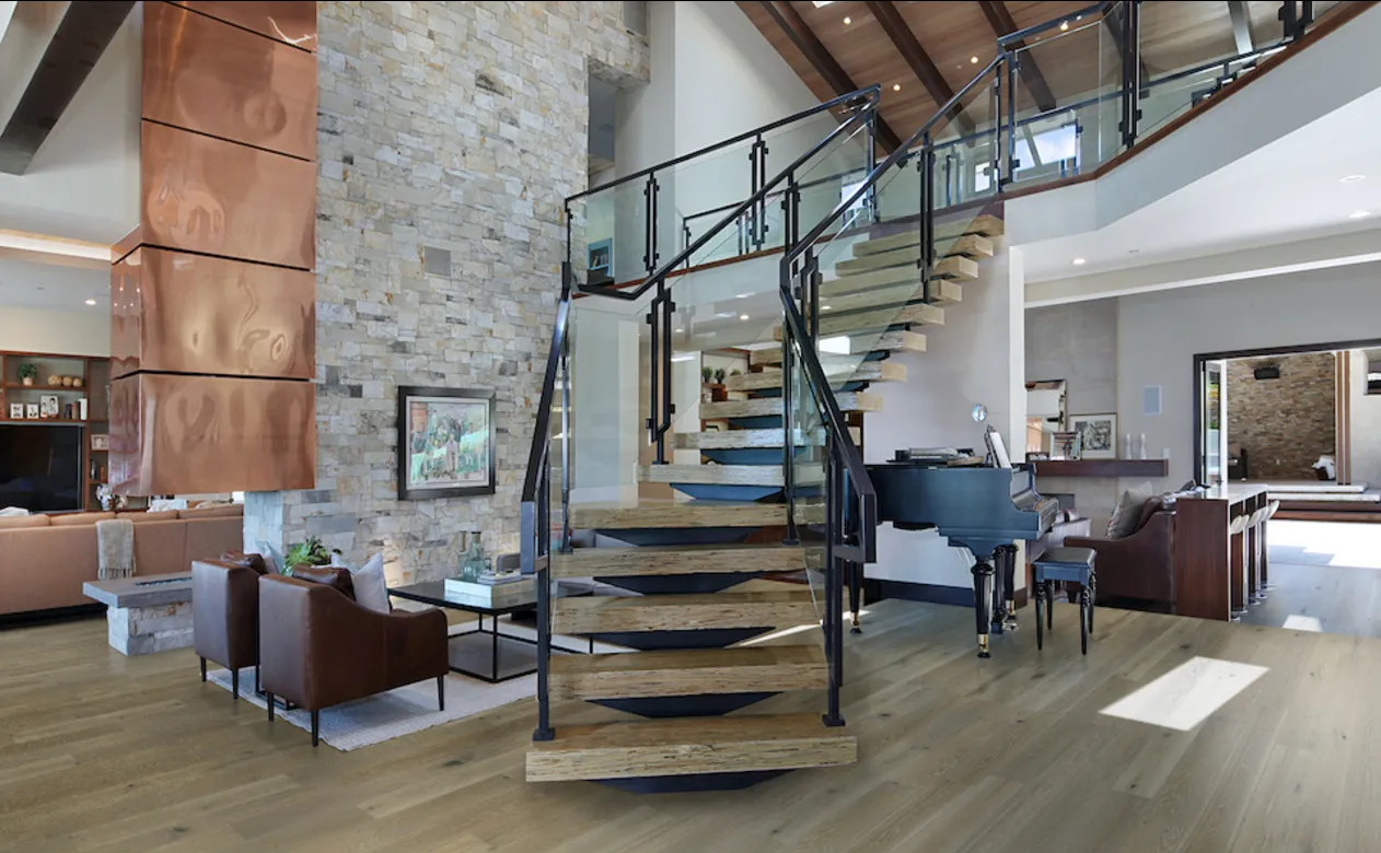 D&M Hardwood flooring in medium brown shade in living room and on staircase