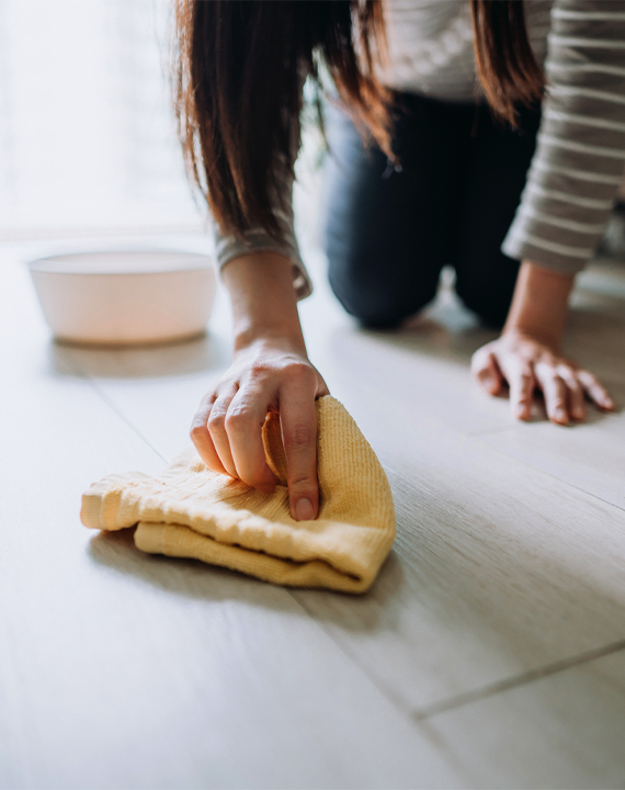 Women wiping up spill on easy care floors 